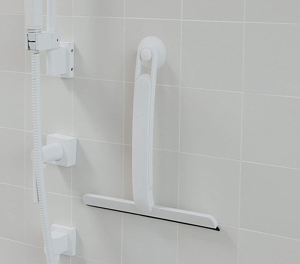 the squeegee hanging in a shower