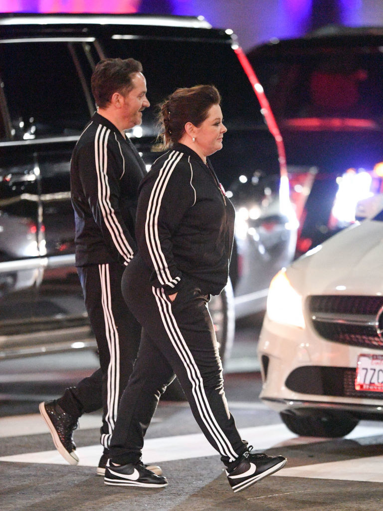 Melissa McCarthy and Ben Falcone are seen crossing a street in their matching tracksuits 