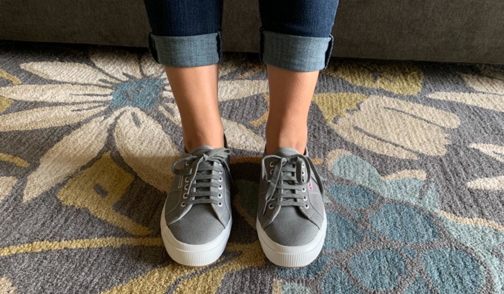 reviewer wearing grey superga sneakers