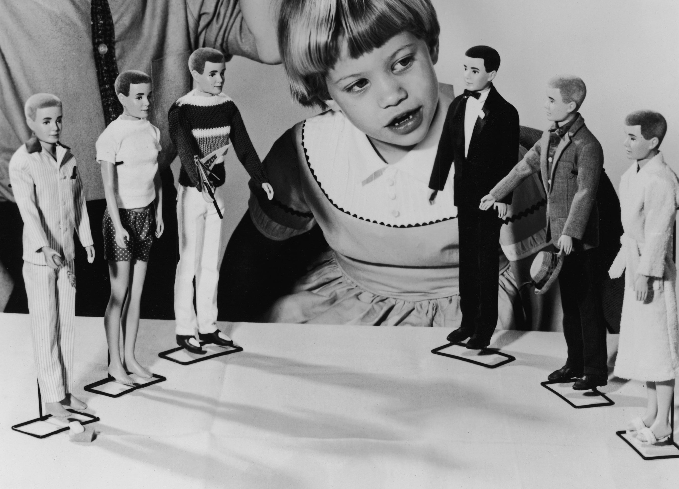 A young girl inspects the new line of &#x27;Ken&#x27; dolls
