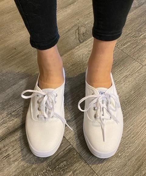 reviewer wearing white keds sneakers