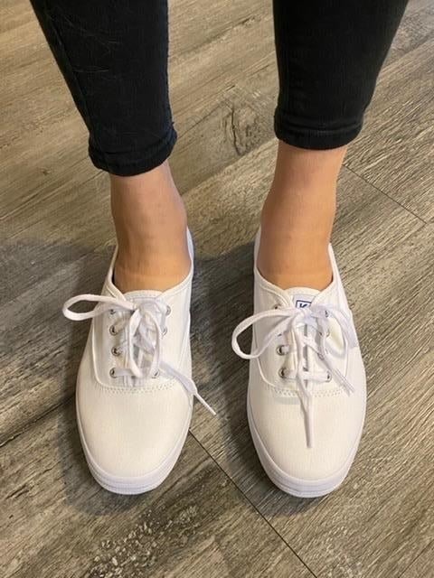 reviewer wearing white keds sneakers