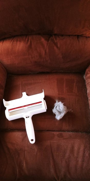 A reviewer's clean couch, ChomChom roller, and a ball of removed hair