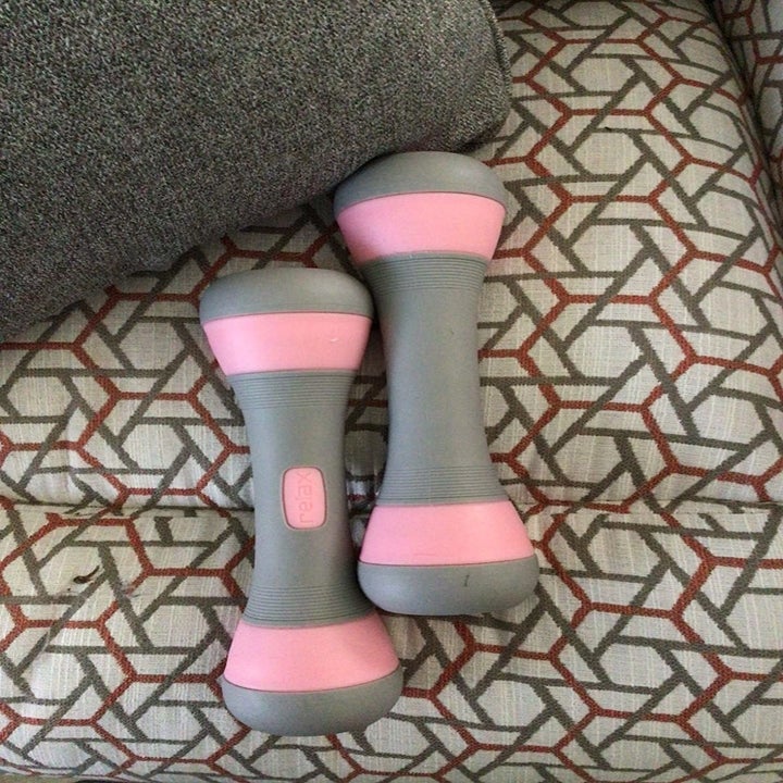 a reviewer's set of gray and pink weights