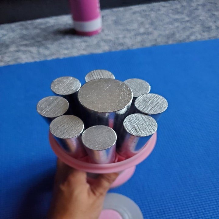 a reviewer showing the multiple mini weights inside the big weight