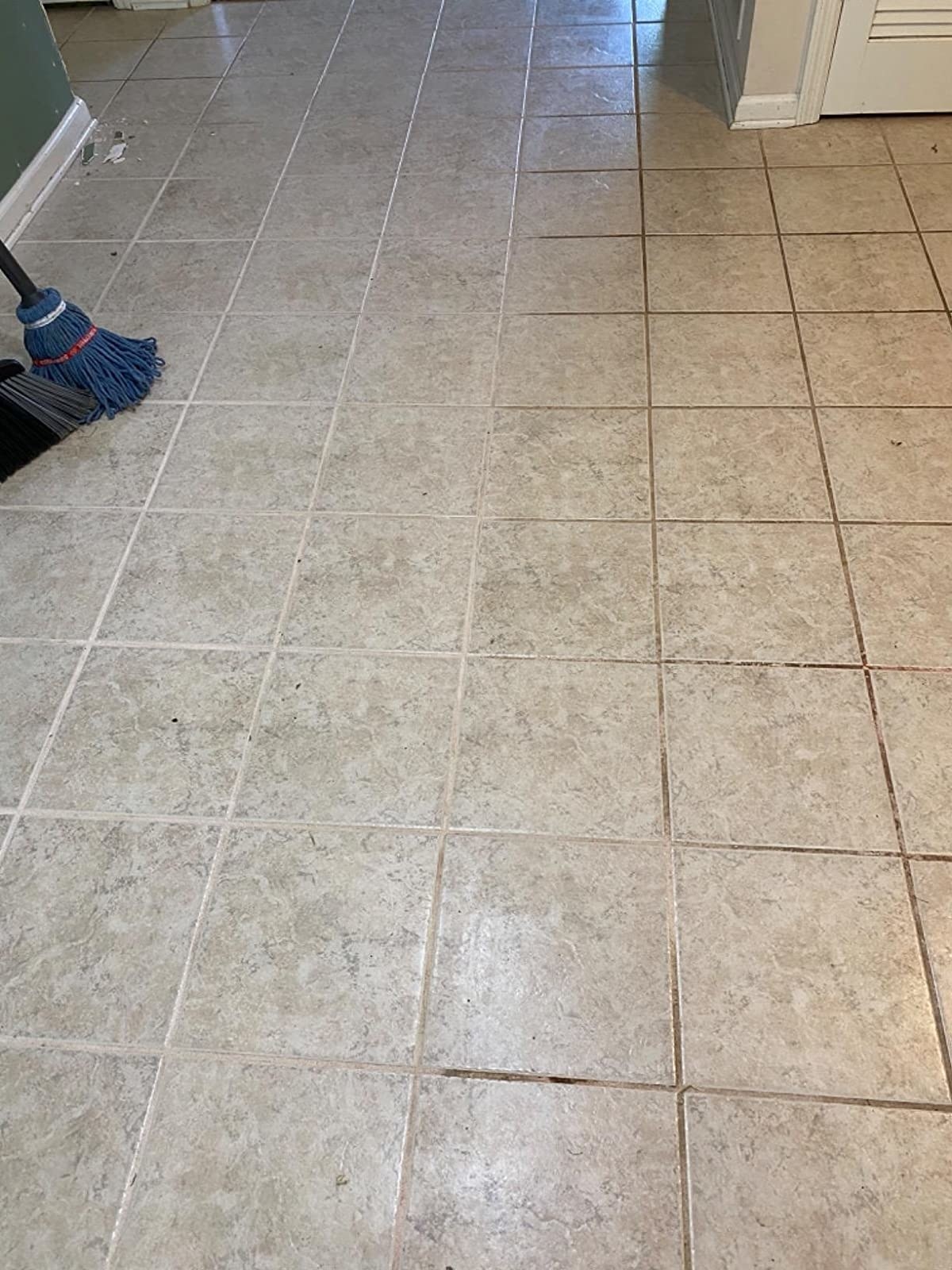 A reviewer demonstrates before and after using the product on floor grout, which was almost black and is now white.