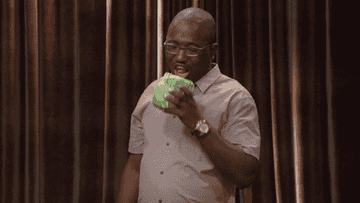 Comedian Hannibal Buress takes a big bite out of a head of lettuce