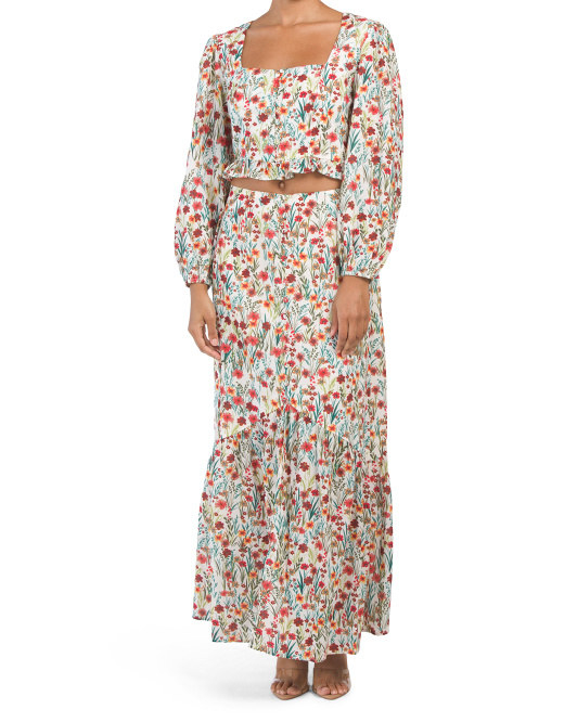 a long sleeve white top with colorful small florals all over it and matching maxi skirt