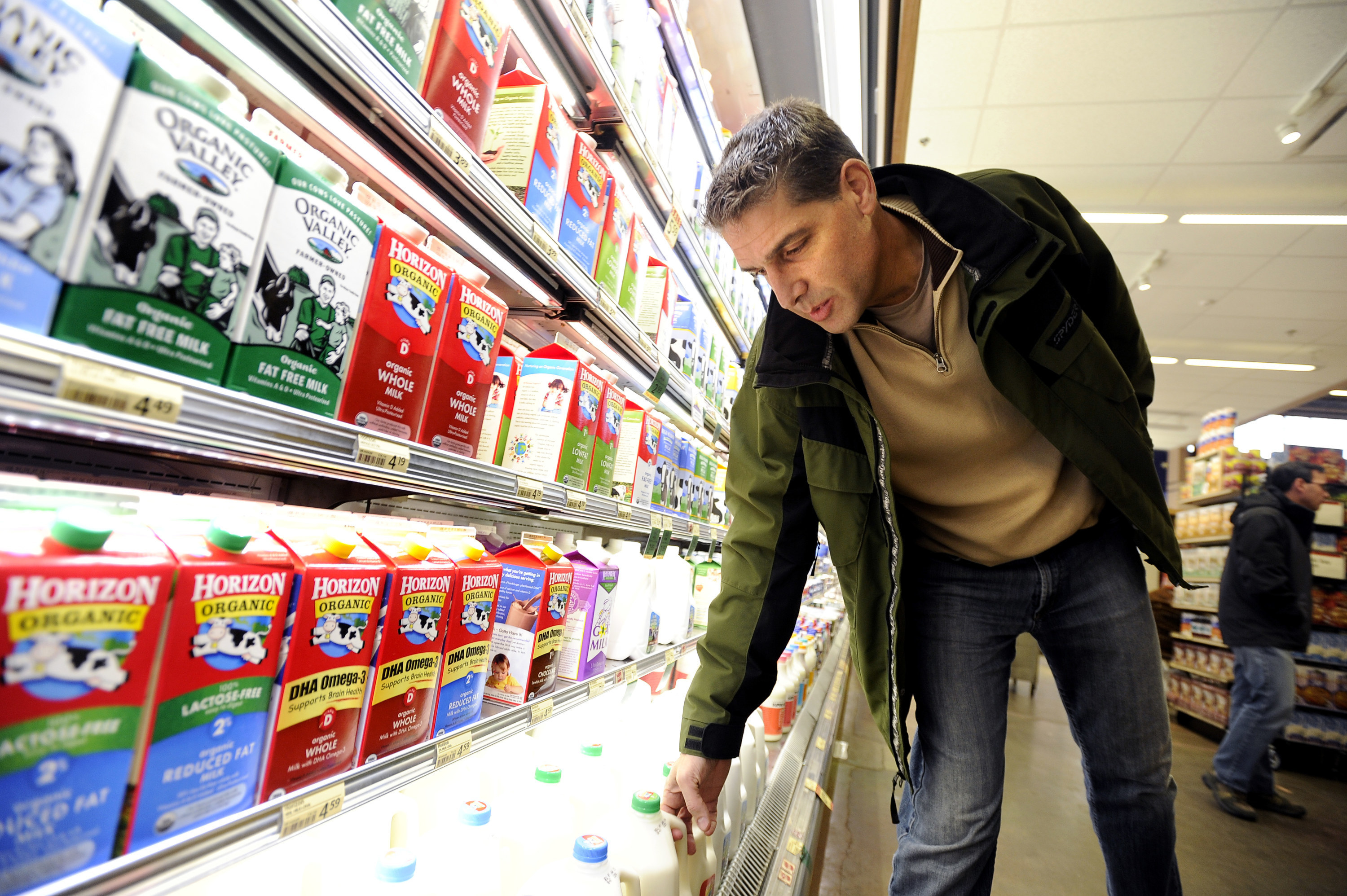 Man in the dairy aisle of the supermarket