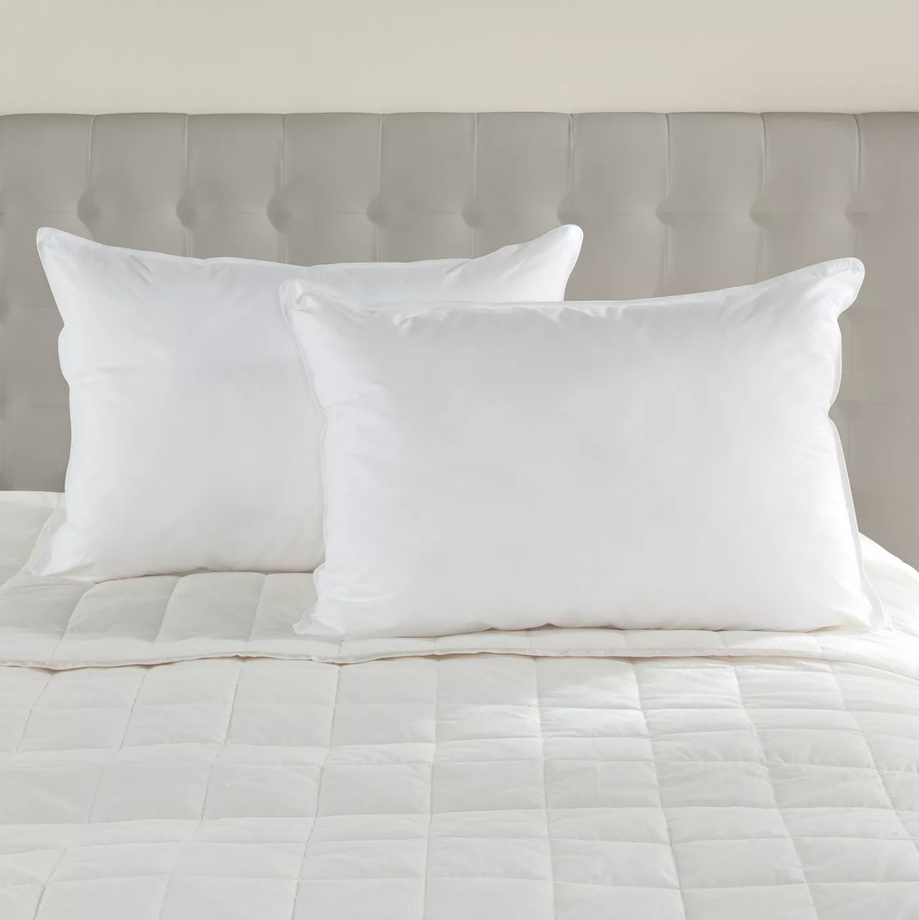 Two white pillows on a bed