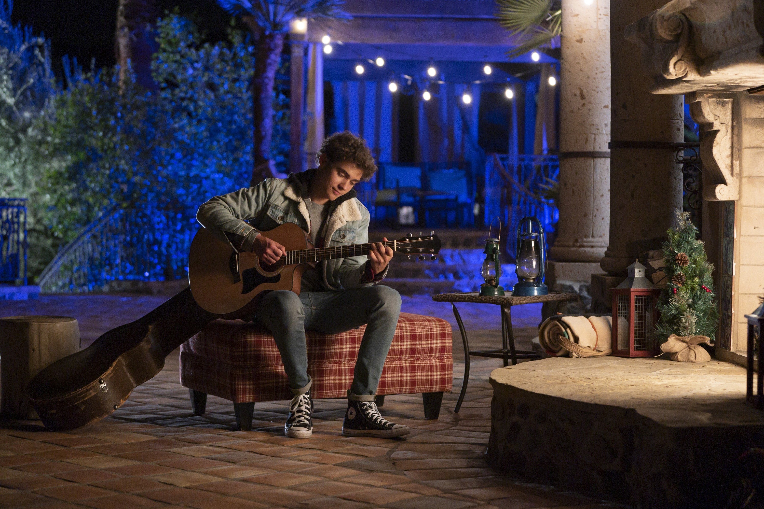 Joshua playing a guitar