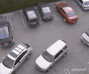 Several cars attempt to park without running into one another. 