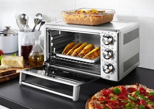 a toaster oven with food inside on a counter