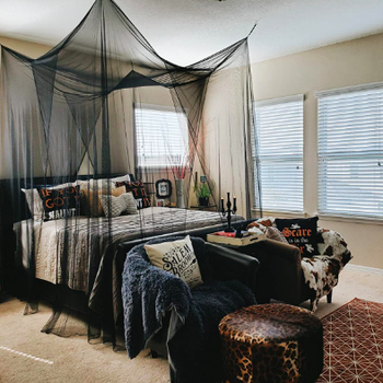 Room with hanging covering the entire bed 