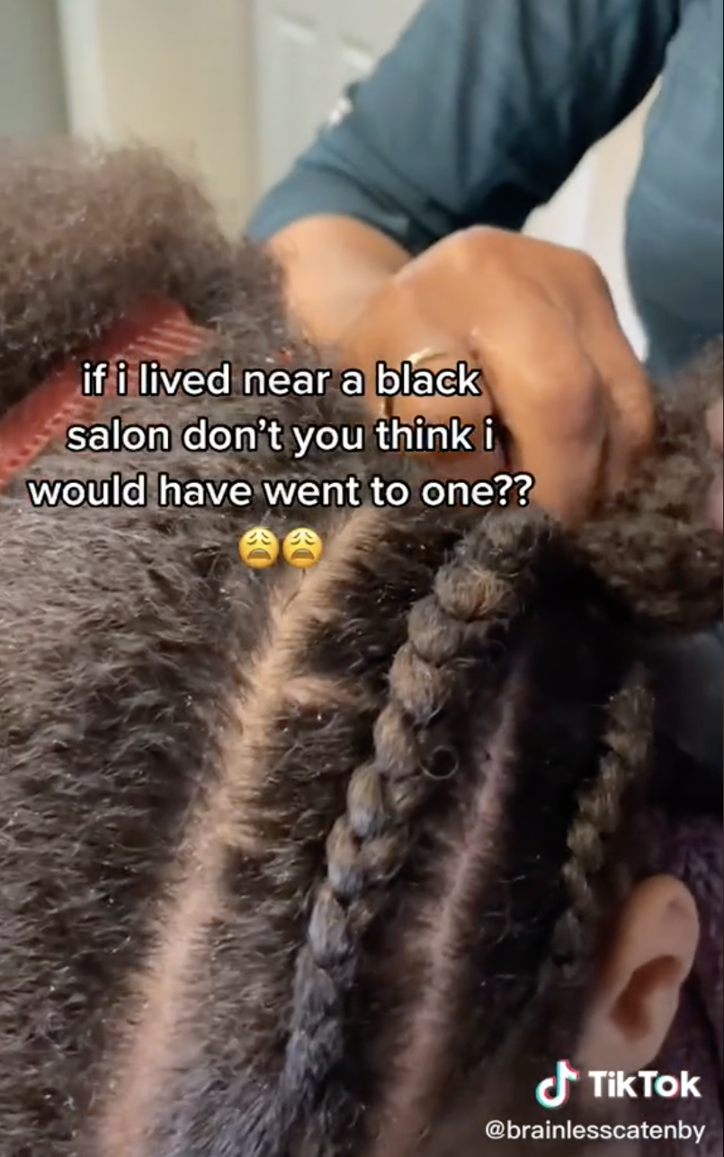A closeup of Mimi getting her hair braided with the caption, &quot;if I lived near a Black salon don&#x27;t you think I would have went to one?&quot;