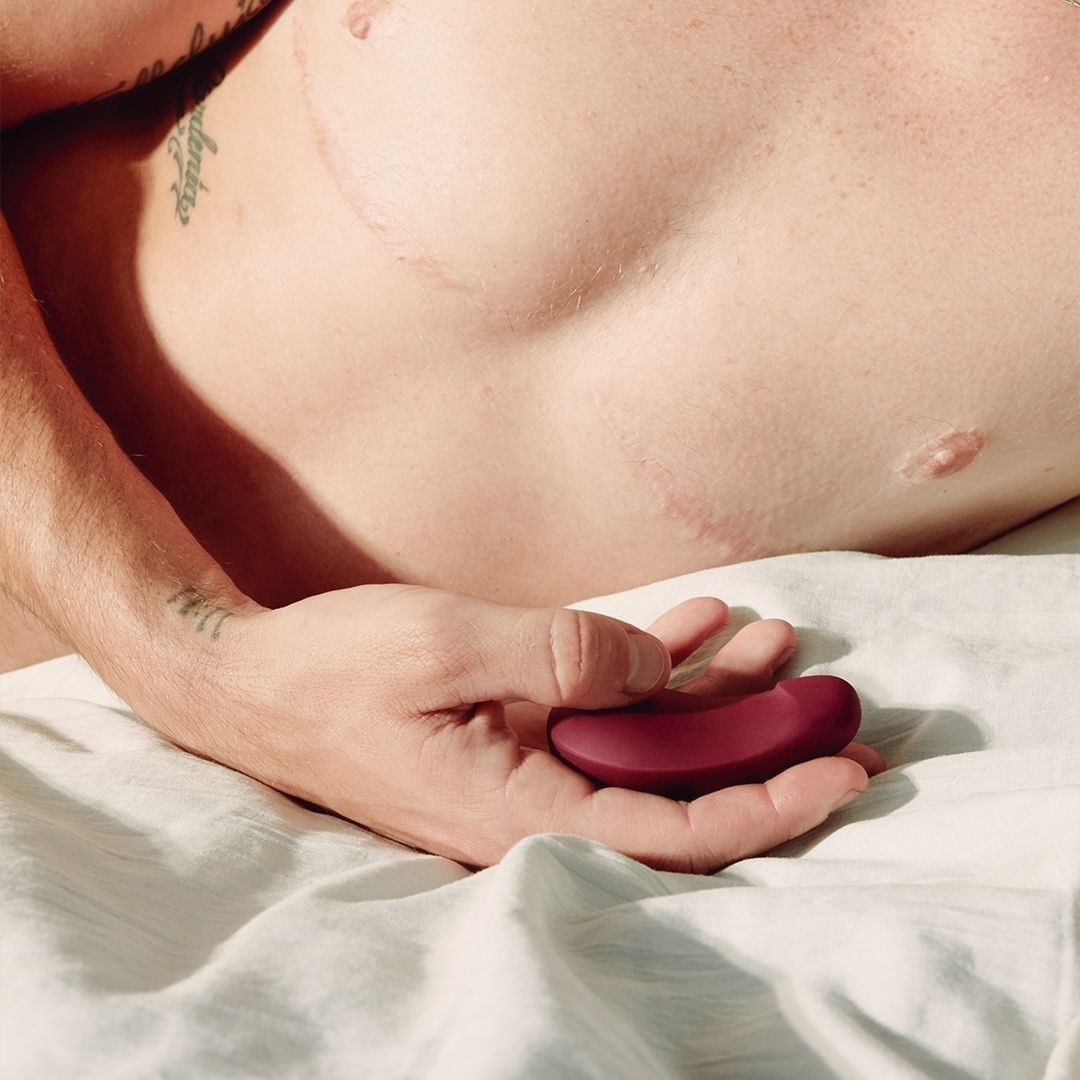 A person holding the palm-sized vibrator 