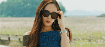 Krystal pulls down her sunglasses in the Bride of Habaek