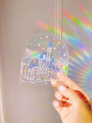 A transparent sticker with outline of Disney castle on it 