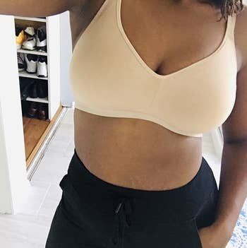 a reviewer wearing the toasted almond bra and sweatpants 