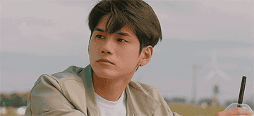 Ong Seong-wu drinks a coffee in a field in More Than Friends