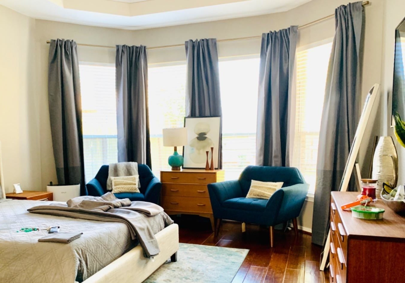 bedroom with curtains hanging from the rods 