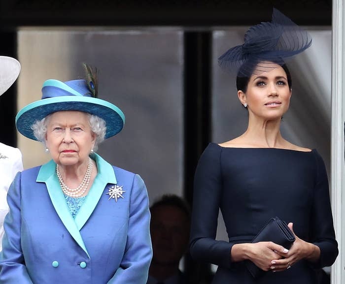 Queen Elizabeth II and Meghan, Duchess of Sussex, stand side by side on a balcony at Buckingham Palace