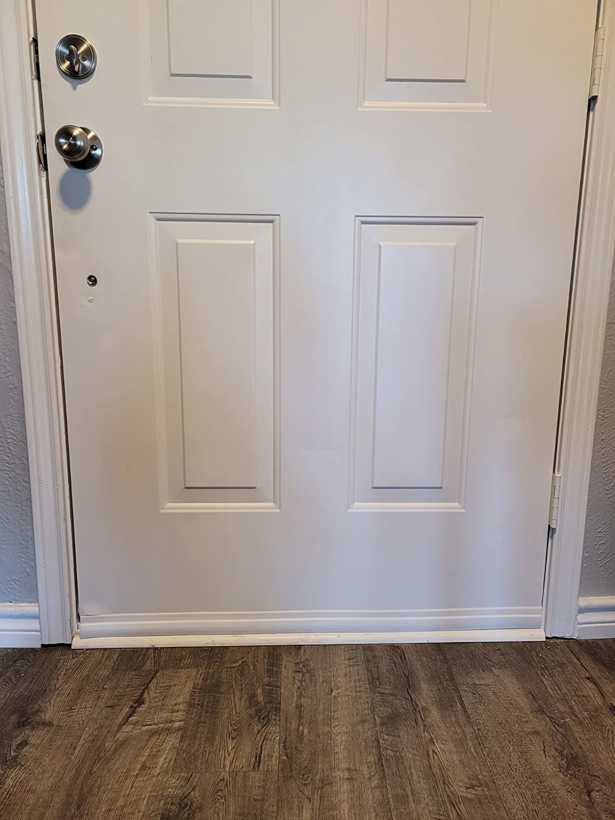 A white draft stopper on a white door