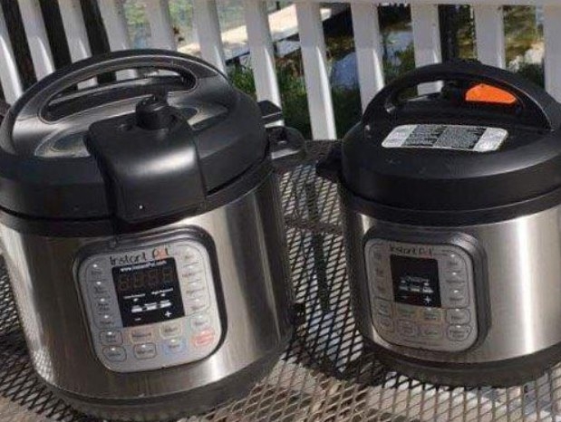Two instant pots, one bigger and one smaller, sit on an iron table.