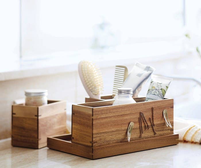 wood vanity organizer with different compartments and beauty supplies inside