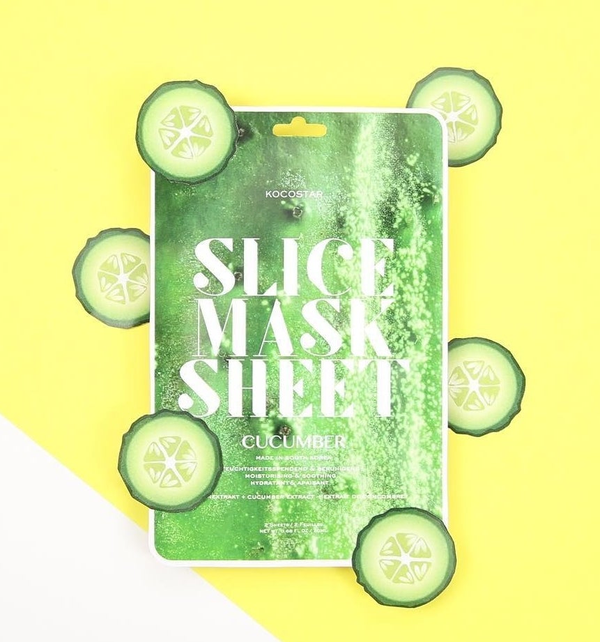 A flatlay of the face masks with the sliced "cucumber" arranged around it
