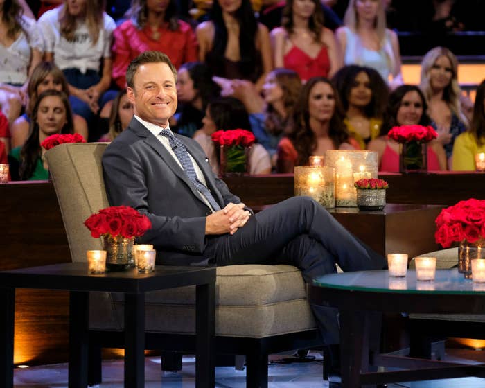 Chris sitting on the tell-all set with the audience in the background