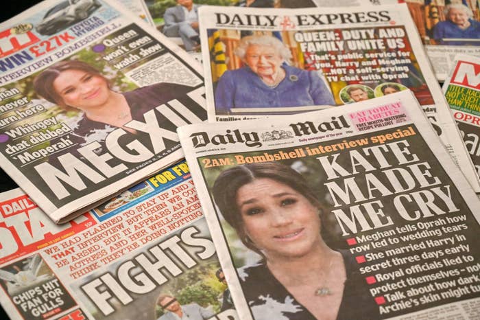 Headlines from UK newspapers featuring conflict between Meghan and the royal family