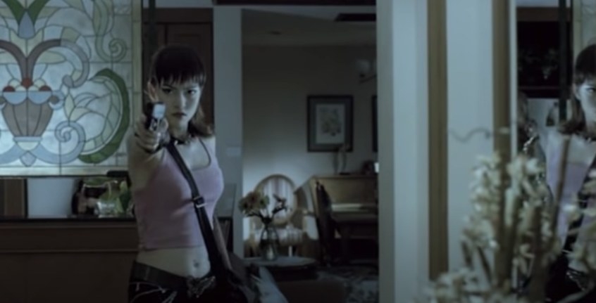 Woman pointing a gun.