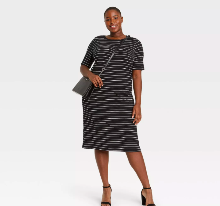 a model wearing the black dress with white stripes