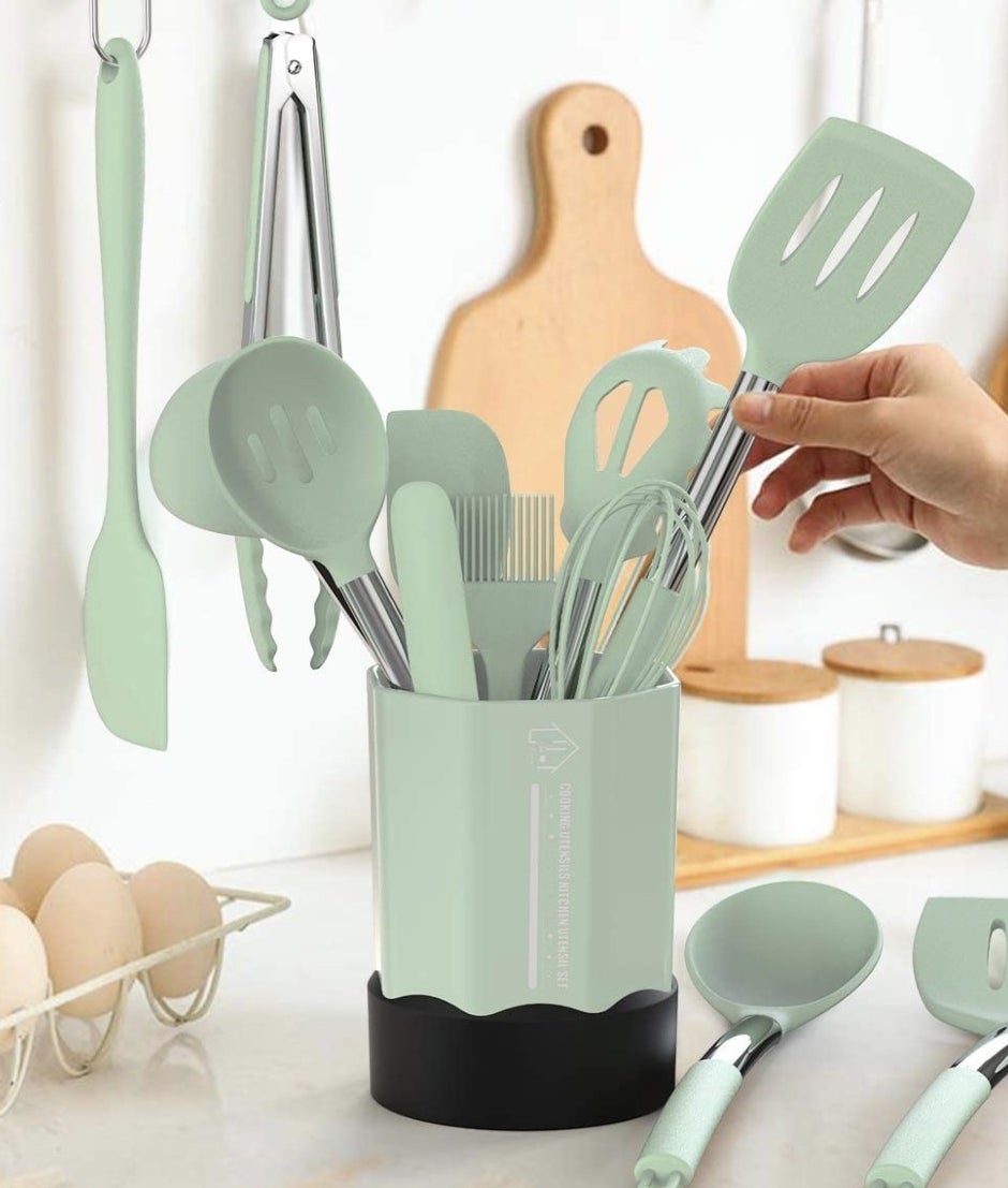 A mint green set of cooking utensils on a kitchen counter