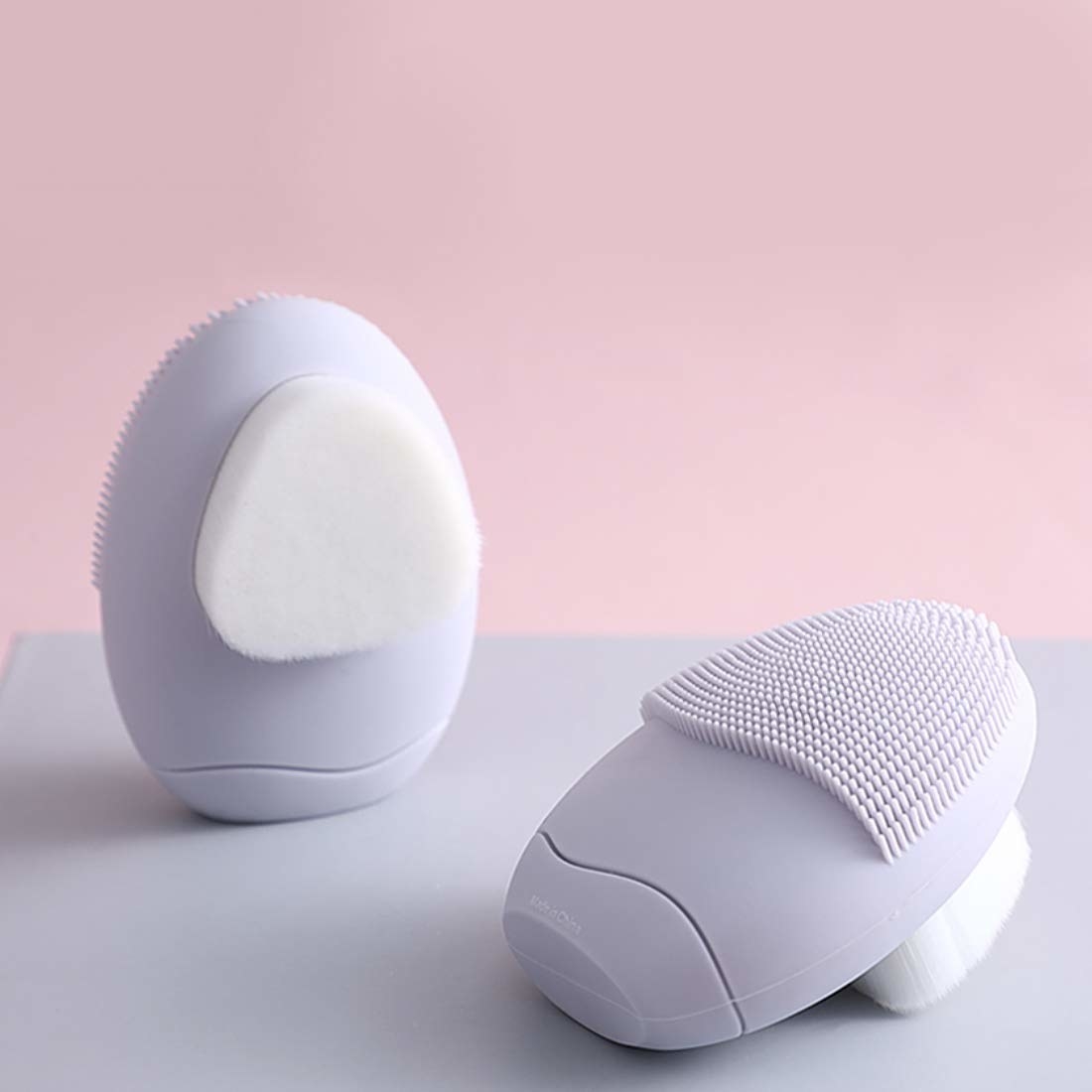 A purple facial cleansing brush with two sides 