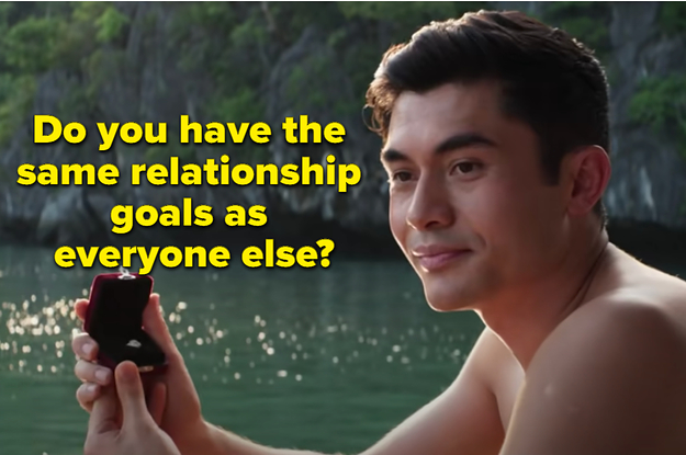 A man is sitting by the water holding an engagement ring with a label that says: