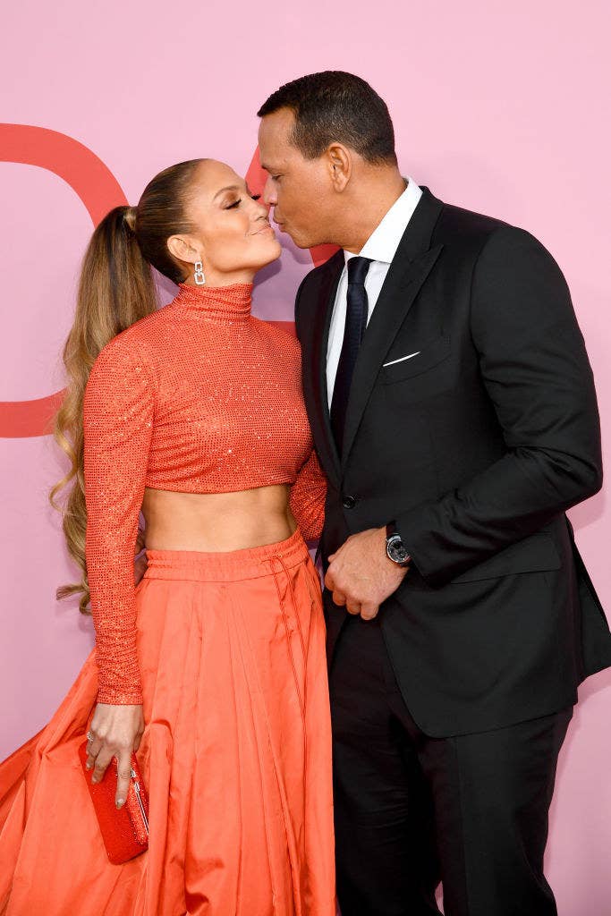 JLo and ARod leaning in for a kiss on the red carpet