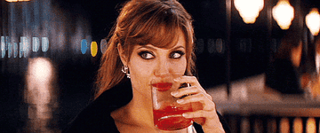 Angelina Jolie drinking a beverage in "Mr. and Mrs. Smith"