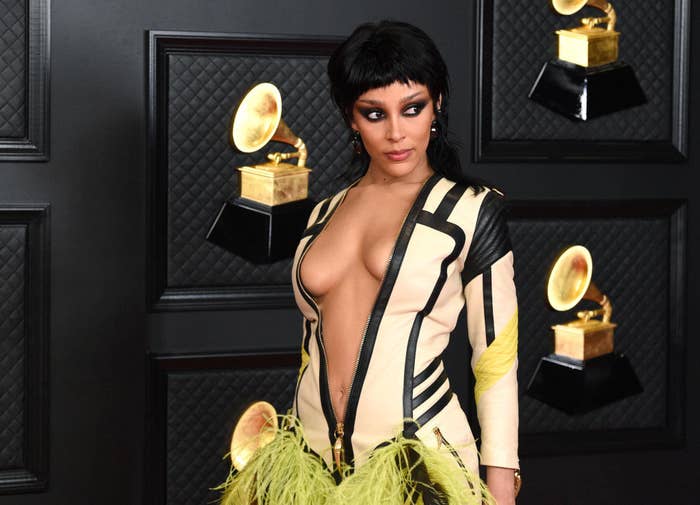 Doja Cat walks the red carpet at the 2021 Grammys in a fitted motorcycle jacket dress 