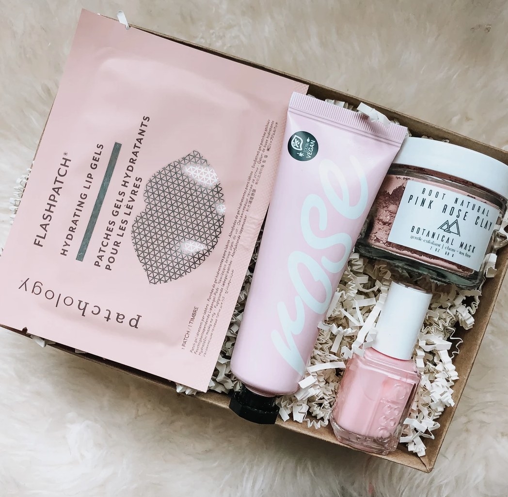 A box with nail polish, lotion, face and lip mask. 