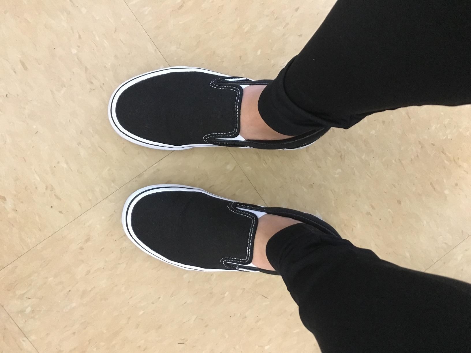 reviewer wearing black vans slip-on trainers