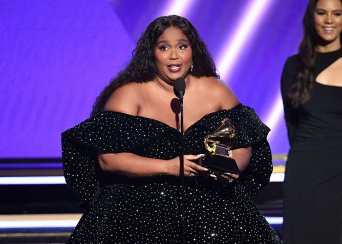 Lizzo holding her Grammy award