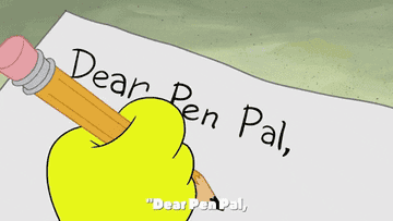 Writing out the words &#x27;Dear pen pal,&#x27; on a piece of paper