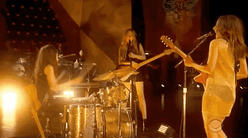 Haim perform in a small circle while looking at each other
