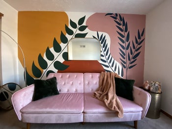 a reviewer's photo of the couch in pink