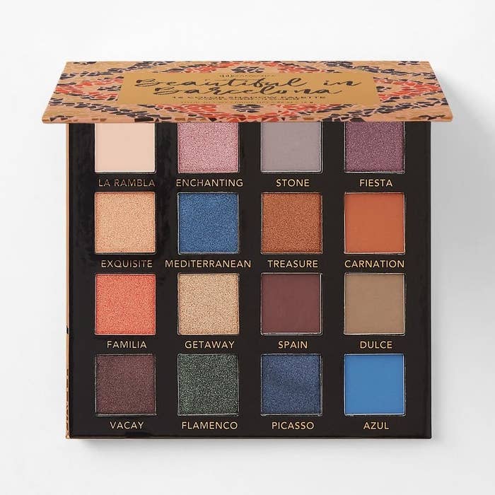 the eyeshadow palette with various shades of blue, dark red, and rose gold