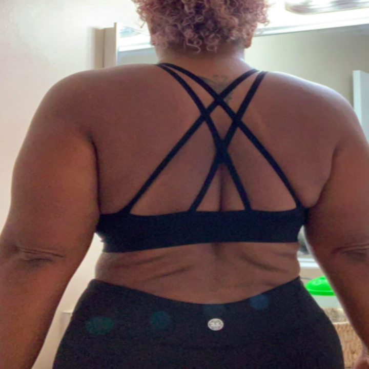 Reviewer showing the crisscross, strappy back 
