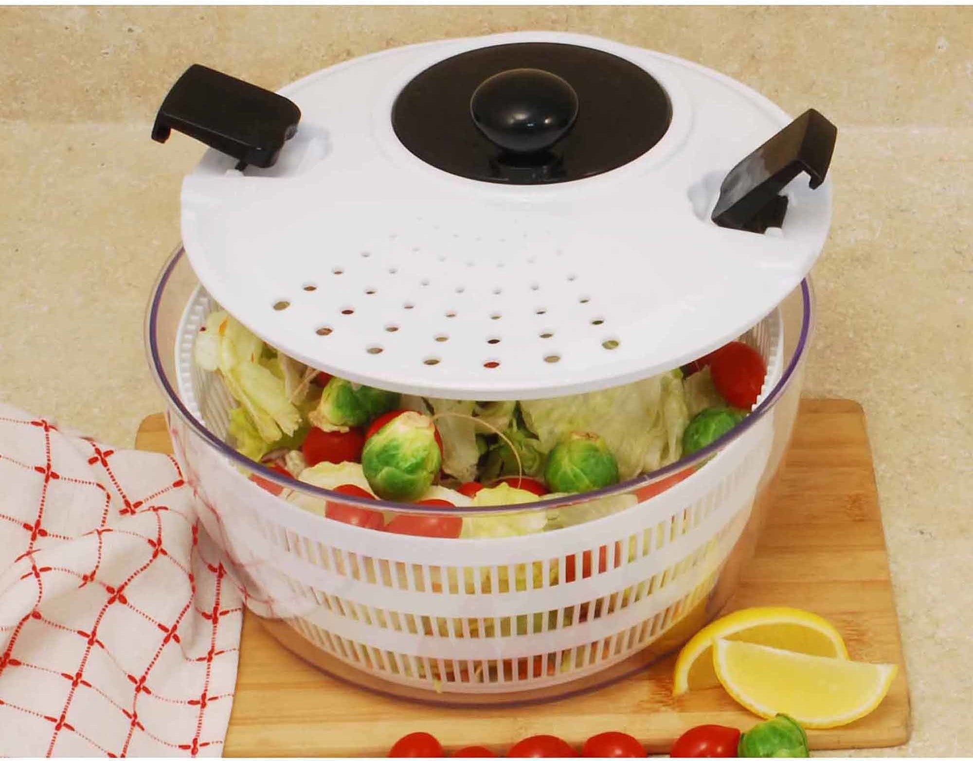 a salad spinner with vegetables inside