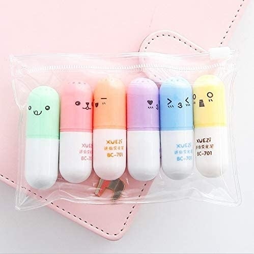 six pill-shaped highlighters with cute faces on the lids 